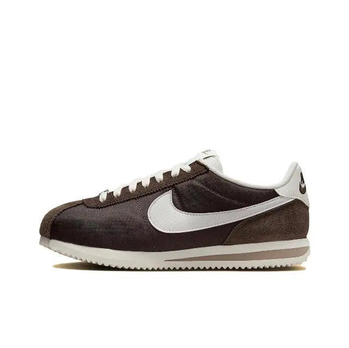 Nike Cortez sneakers in dark brown with white Swoosh and white midsole, lace-up.