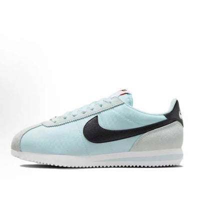 Light blue low-top sneakers with black Nike Swoosh and white rubber sole