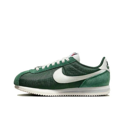 Nike Cortez sneakers in dark green with white Swoosh and lace-up front.