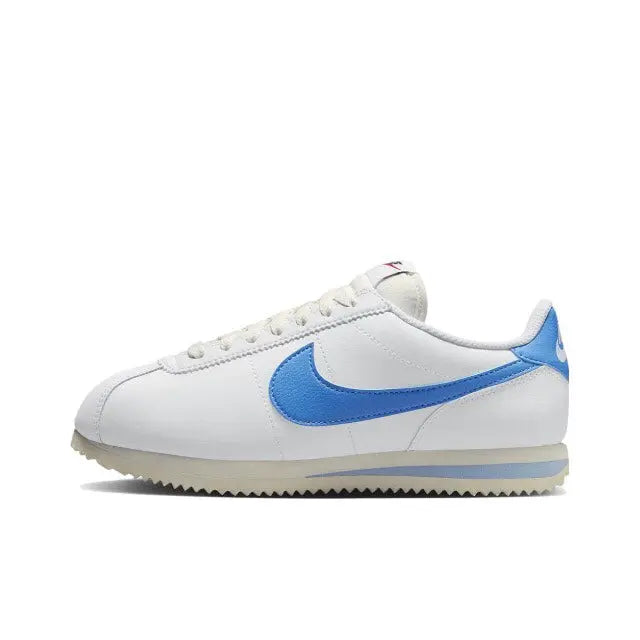 Nike Cortez sneakers in white with blue swoosh and lace-up side view