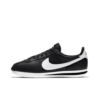 Black low-top sneaker with white swoosh and striped midsole
