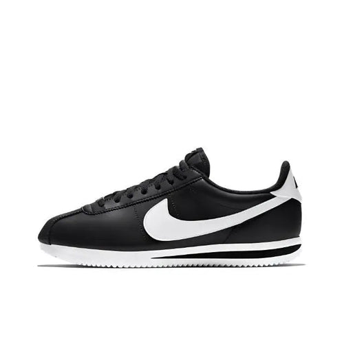 Black low-top sneaker with white swoosh and striped midsole