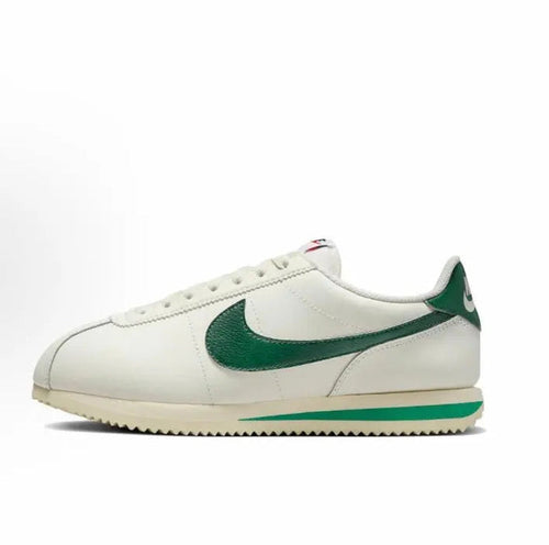 Nike Cortez sneakers in white with green swoosh and striped rubber sole