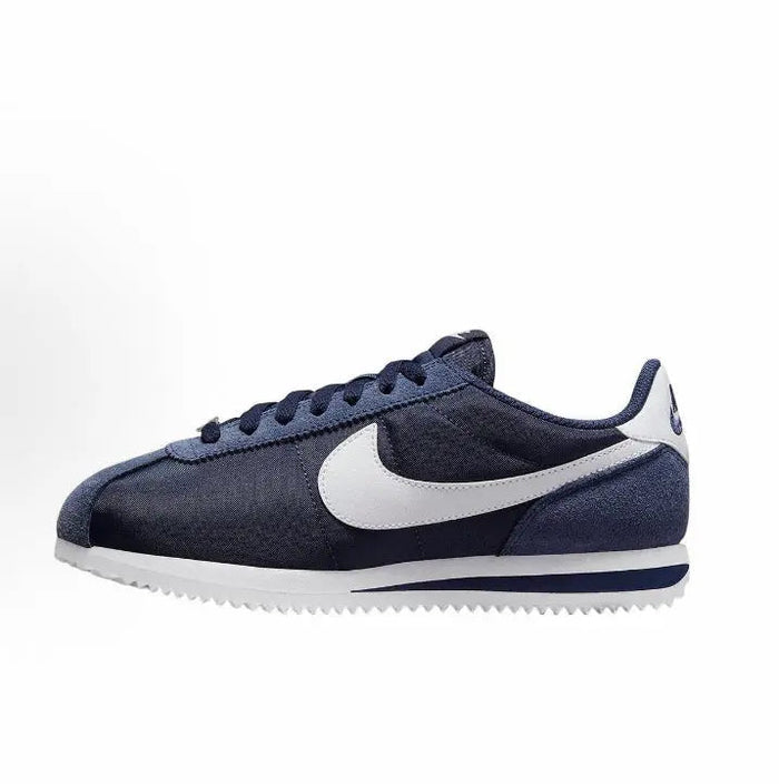 Nike Cortez low-top sneakers in dark blue with white swoosh and lace-up design