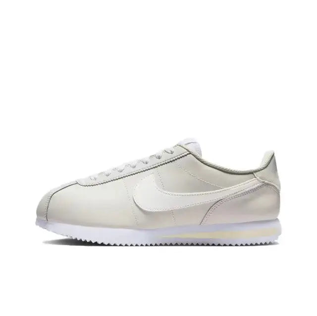 Nike Cortez low-top sneakers, white with side Swoosh and lace-up front.