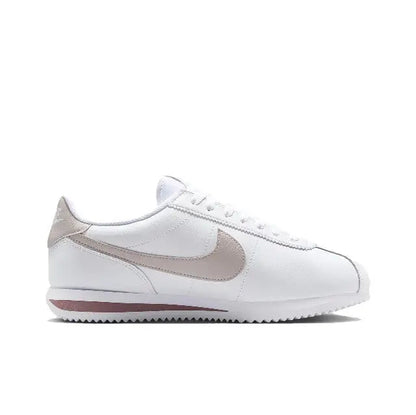 Low-top sneakers with white leather uppers and beige swoosh, lace-up front