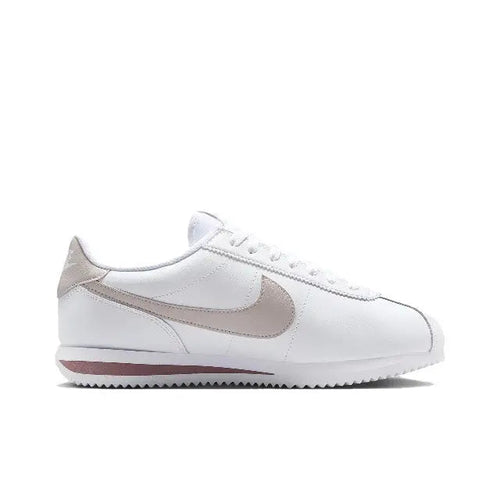 Low-top sneakers with white leather uppers and beige swoosh, lace-up front