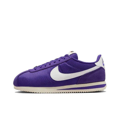 Nike Cortez low-top sneakers in purple with white swoosh and lace-up front
