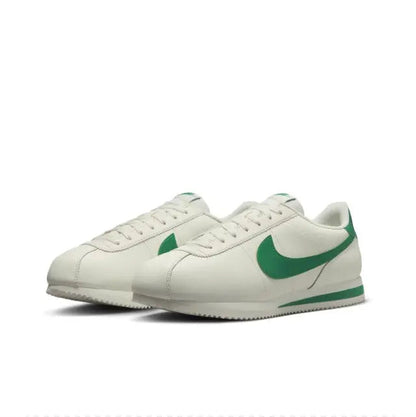 Low-top sneakers, white with green Swoosh, lace-up front