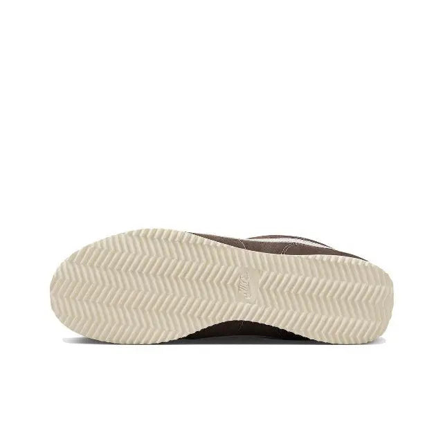 Brown low-top sneakers with zigzag tread and white rubber outsole