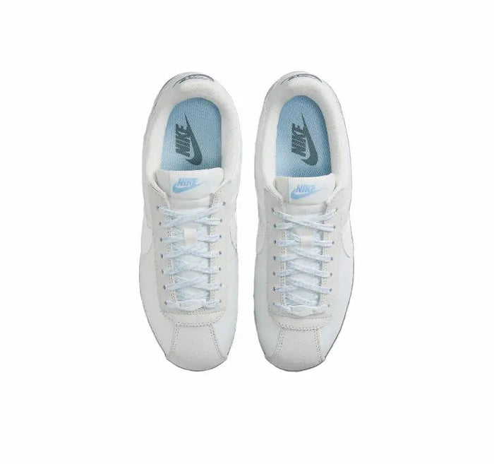 White Nike low-top sneakers, top view with laces and blue lining