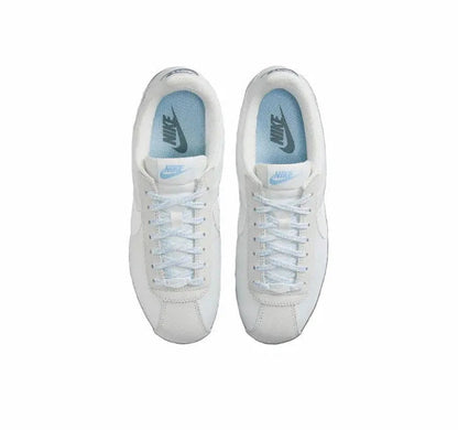 White Nike low-top sneakers, top view with laces and blue lining