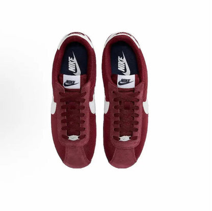 Wine red sneakers with navy Nike heel label, lace-up tongue and laces visible