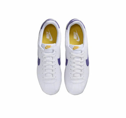 Cortez sneakers, white uppers with purple heel tab; laces visible