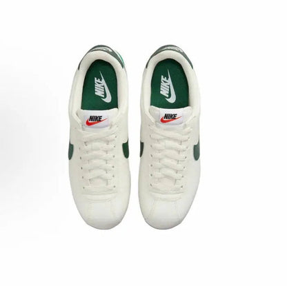 White Cortez sneakers with green heel details and lace-up front
