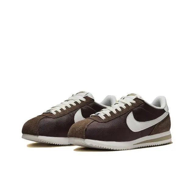 Nike Cortez sneakers pair in dark brown with white Swoosh panels, lace-up.