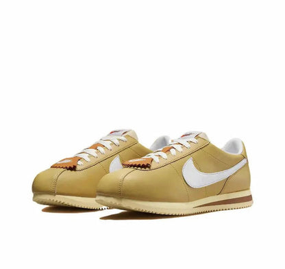 Cortez sneakers, wheat gold uppers with white Swoosh, lace-up and brown sole