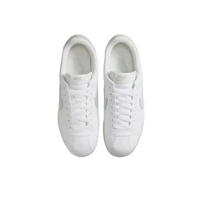 White low-top sneakers shown from the front with lace-up closure