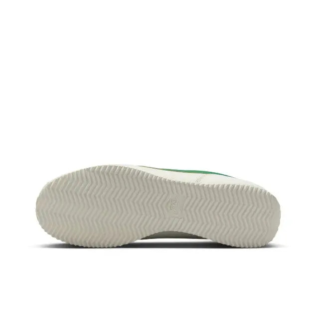 Low-top sneakers outsole view, textured tread with green accent