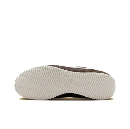 Nike Cortez outsole tread with zigzag pattern, dark brown heel and white rubber.