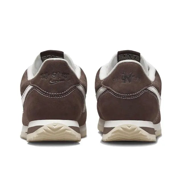 Brown low-top sneakers with white heel stripe and back pull-tab
