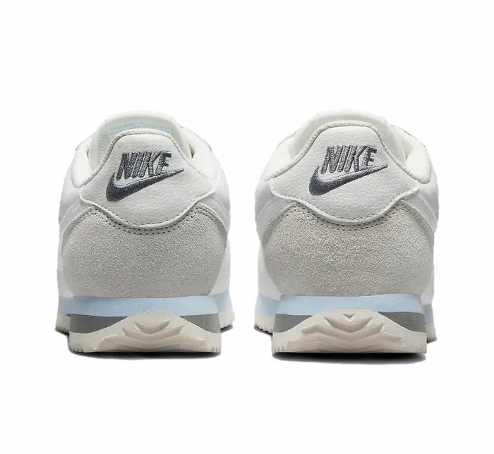 White low-top sneakers with NIKE heel logo and cushioned back
