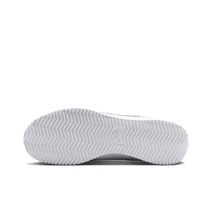 Low-top sneaker outsole with zigzag tread and Nike swoosh on sidewall