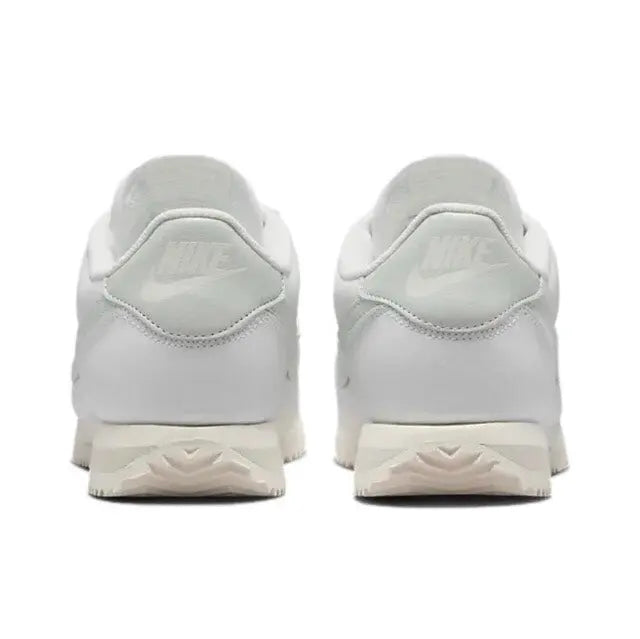 White low-top sneakers with padded heel and lace-up closure