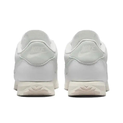 White low-top sneakers with padded heel and lace-up closure