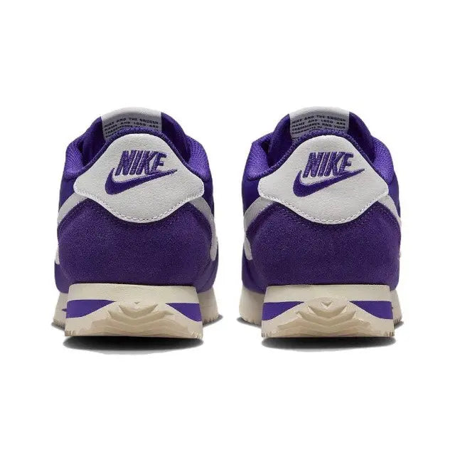 Purple low-top sneakers with white heel panel, Nike branding, and cream midsole