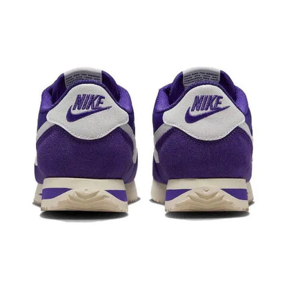 Purple low-top sneakers with white heel panel, Nike branding, and cream midsole
