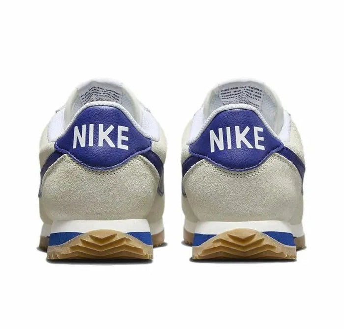 Cortez sneakers from heel view with Nike logo, blue tab and gum sole