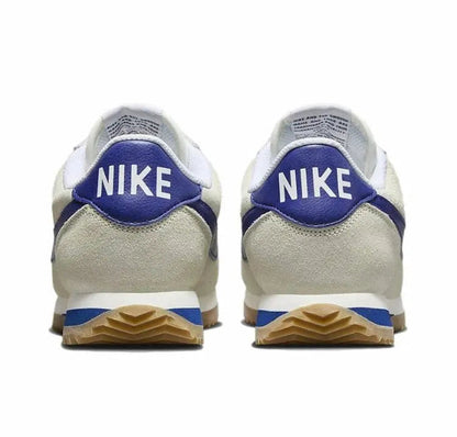Cortez sneakers from heel view with Nike logo, blue tab and gum sole