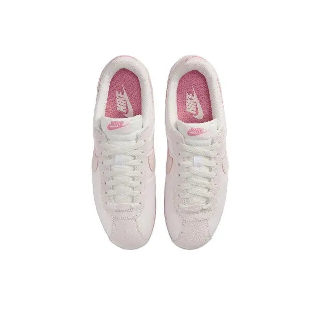 Nike Cortez sneakers pair with laces, light pink uppers and pink interior lining