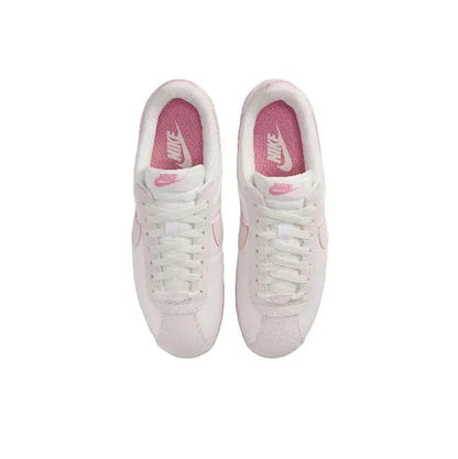 Nike Cortez sneakers pair with laces, light pink uppers and pink interior lining