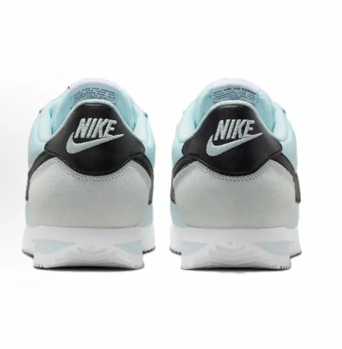 Light blue low-top sneakers with black Nike heel tab and white midsole