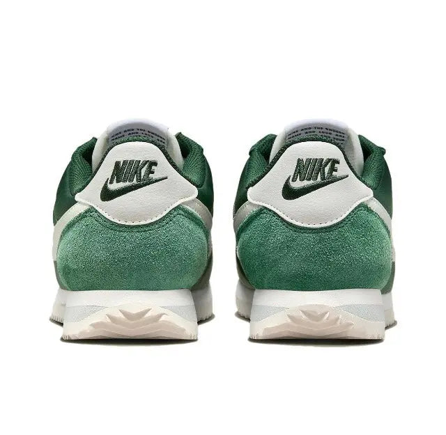 Nike Cortez sneakers with green heel, white N branding, and white midsole.