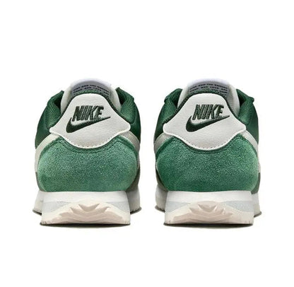 Nike Cortez sneakers with green heel, white N branding, and white midsole.