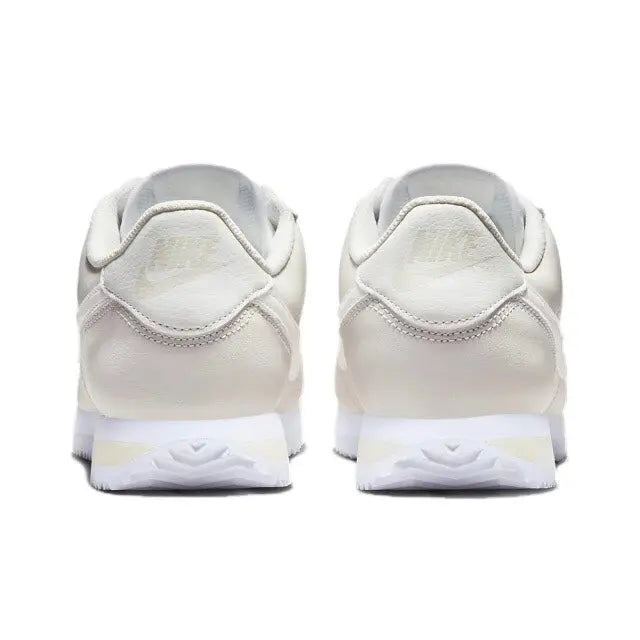 Nike Cortez heel view, white sneakers with padded heel collar and lace loops.