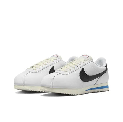 Nike Cortez low-top sneakers, white leather, black Swoosh, blue heel stripe, lace-up