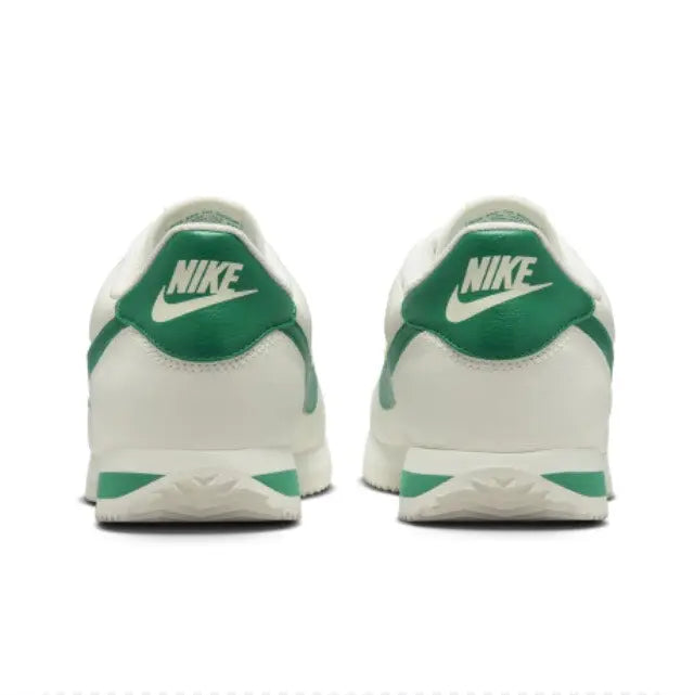 Low-top sneakers heel view, green back panel with Nike logo