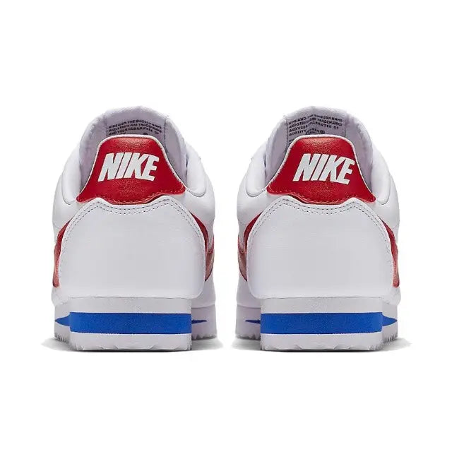 White Nike Cortez sneakers heel view with red Nike logo and blue sole stripe