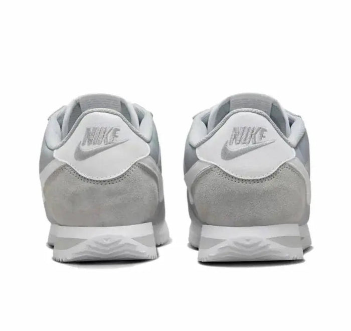 Nike low-top sneakers rear view with gray suede and white Nike logo on heels