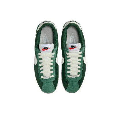 Nike Cortez sneakers with green suede uppers, white laces, and Nike tongue tag.