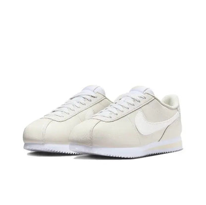 Nike Cortez low-top sneakers pair, white uppers with Swoosh and white laces.