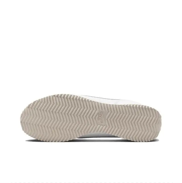 White sneaker outsole with zigzag tread and heel logo detail