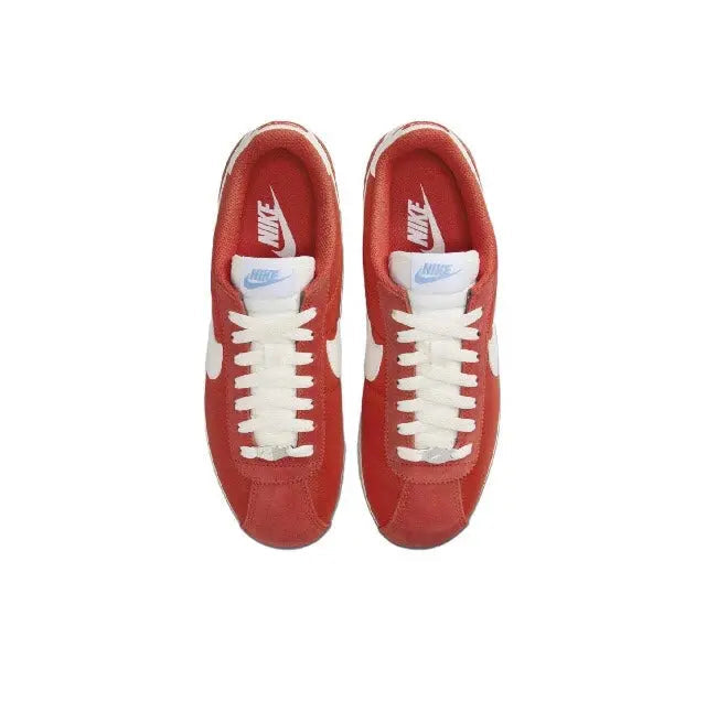 Cortez sneakers top view: red uppers, white laces, Nike mark at tongue