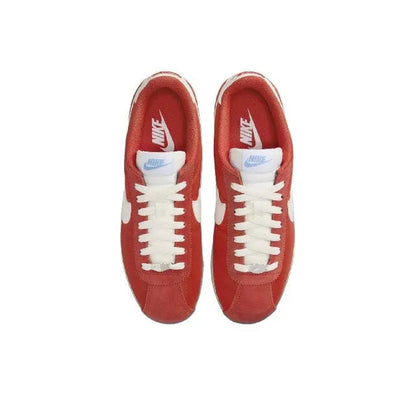 Cortez sneakers top view: red uppers, white laces, Nike mark at tongue