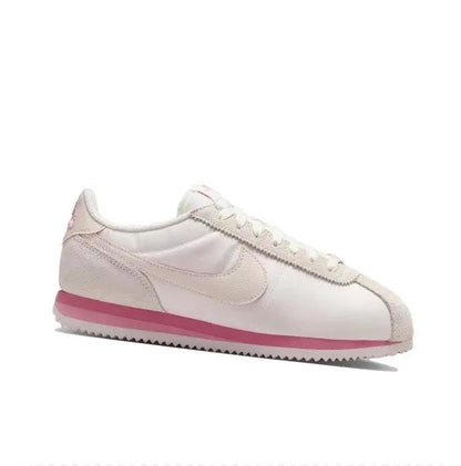 Nike Cortez low-top sneakers side view in light pink with pink midsole and swoosh