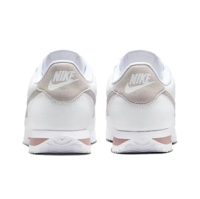 Low-top sneakers heel view with Nike logo on back and white leather upper